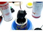 The servo can be dipped or painted with Plasti Dip. Painting along the joints is probably better.